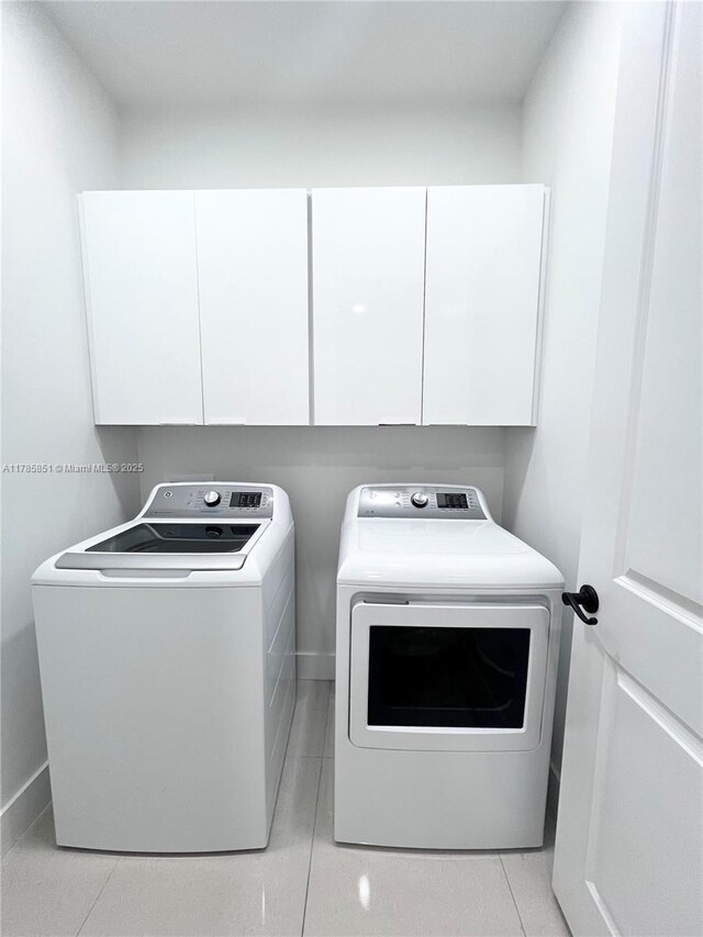 314 Chiquita Blvd N, Cape Coral, FL 33993 - clothes washing area with washing machine and dryer, cabinet space, light tile patterned floors, and baseboards