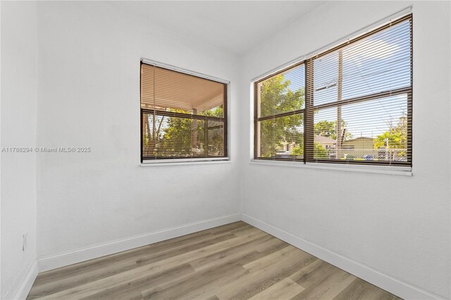 720 NW 6th St, Hallandale Beach, FL 33009 - unfurnished room with plenty of natural light, baseboards, and light wood finished floors