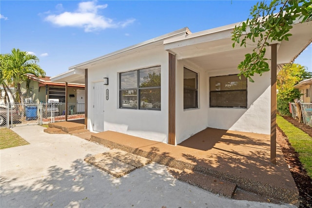 720 NW 6th St, Hallandale Beach, FL 33009 - view of front of home featuring stucco siding and a patio area
