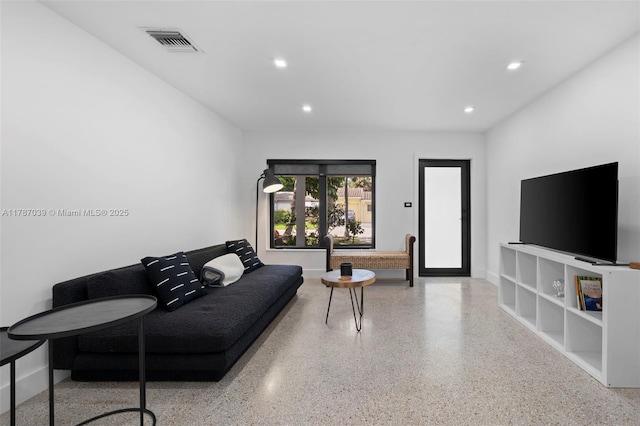 living room featuring speckled floor, visible vents, and recessed lighting