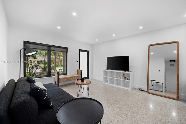 living room with speckled floor, baseboards, and recessed lighting