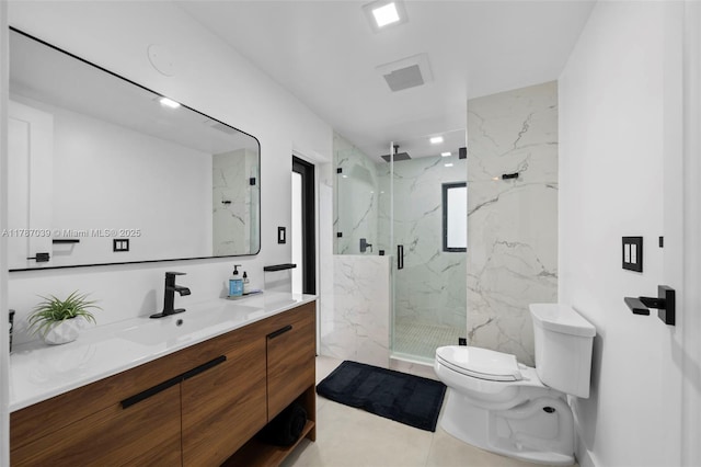 bathroom with tile patterned flooring, toilet, vanity, and a marble finish shower