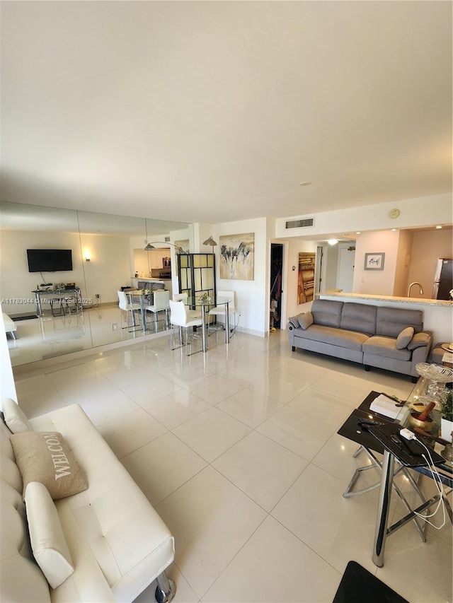 living area featuring visible vents and tile patterned flooring