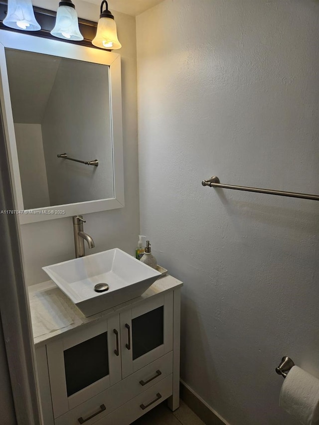 bathroom with baseboards and vanity