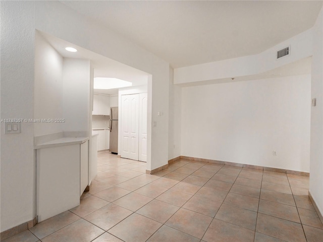 unfurnished room featuring recessed lighting, visible vents, baseboards, and light tile patterned floors