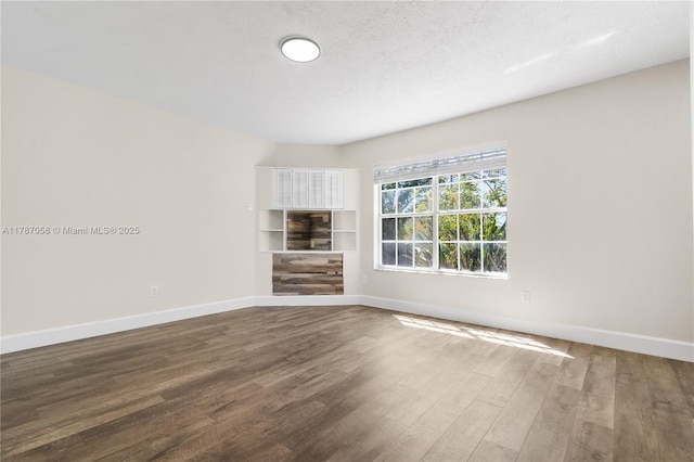 461 SE Evans Ave, Port St Lucie, FL 34984 - empty room with wood finished floors and baseboards