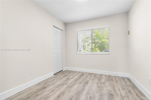 461 SE Evans Ave, Port St Lucie, FL 34984 - empty room featuring wood finished floors and baseboards