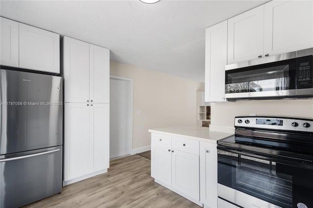 461 SE Evans Ave, Port St Lucie, FL 34984 - kitchen with stainless steel appliances, white cabinetry, and light countertops
