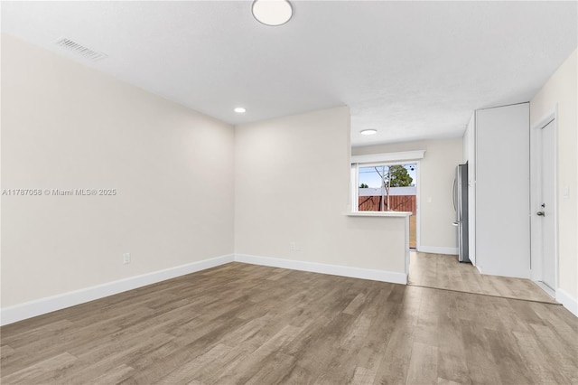461 SE Evans Ave, Port St Lucie, FL 34984 - spare room with light wood-style floors, baseboards, and recessed lighting