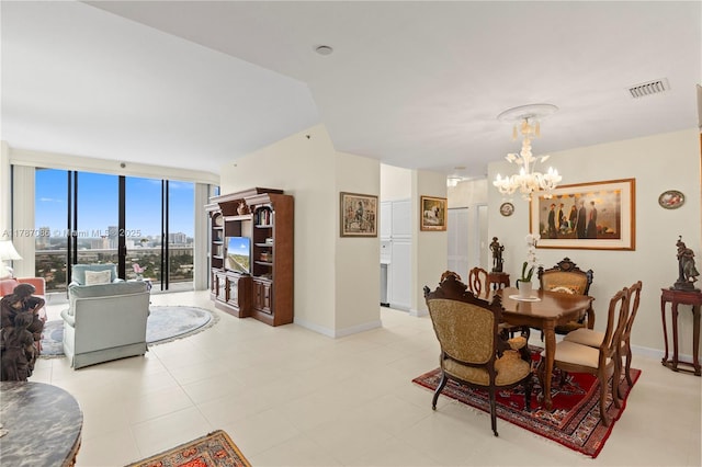 dining area with baseboards, visible vents, and a notable chandelier