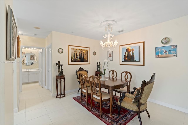 dining area with baseboards, an inviting chandelier, visible vents, and light tile patterned floors