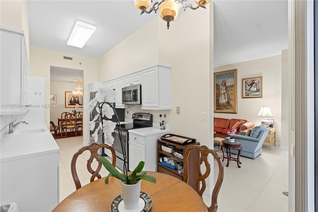 dining room featuring visible vents, a notable chandelier, and light tile patterned floors