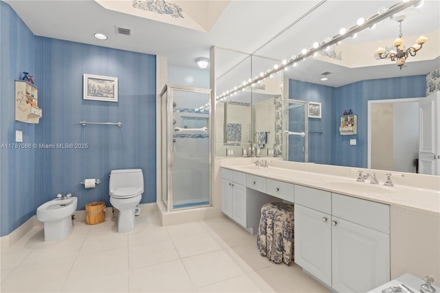 bathroom with a sink, toilet, a bidet, tile patterned flooring, and a shower stall