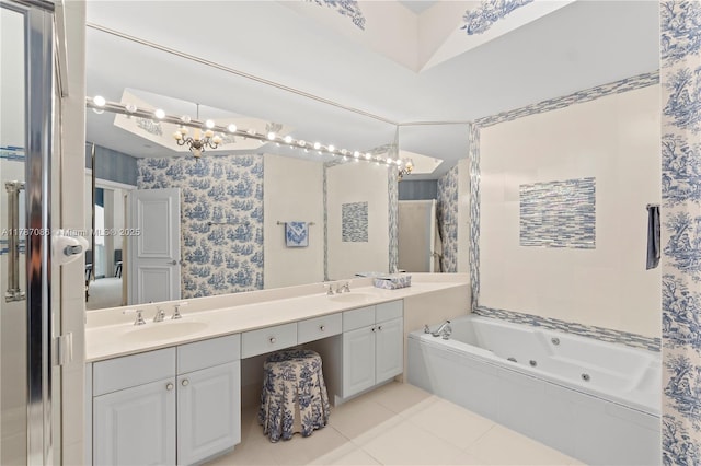 bathroom with tile patterned flooring, a whirlpool tub, a sink, and double vanity