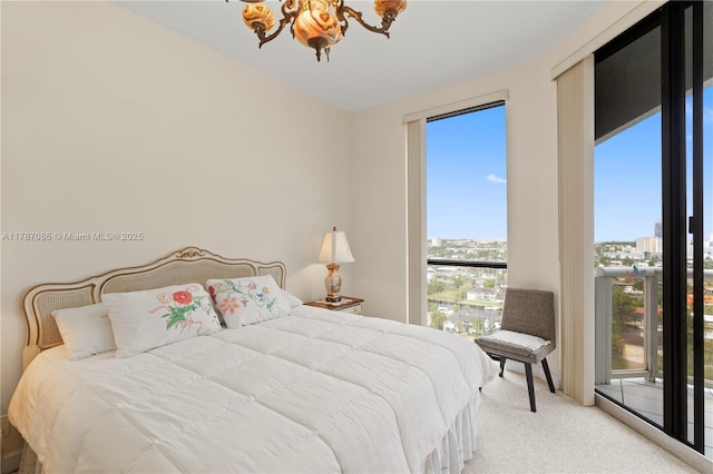 carpeted bedroom featuring a chandelier