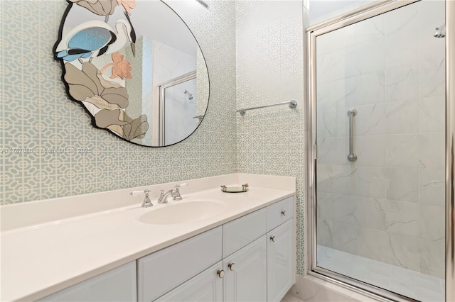bathroom featuring a shower stall and vanity