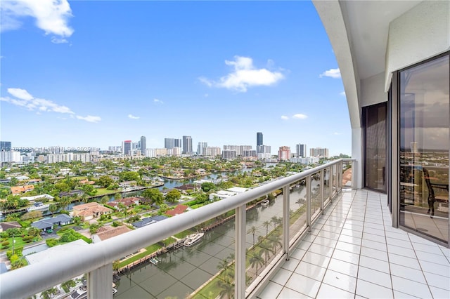 balcony with a water view and a view of city