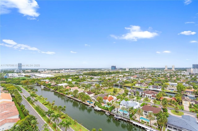 drone / aerial view featuring a city view and a water view