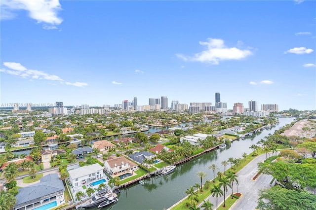 drone / aerial view featuring a city view and a water view