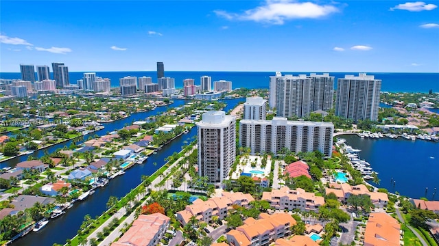 birds eye view of property with a water view and a view of city