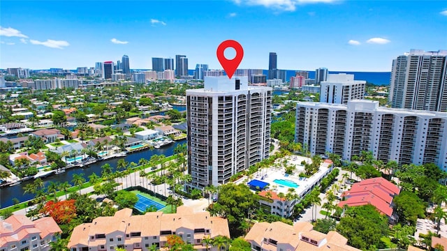 birds eye view of property with a water view and a view of city