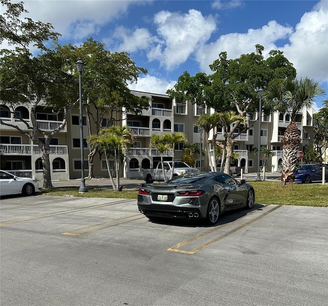 view of building exterior with uncovered parking