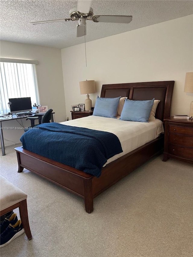 bedroom with carpet, a textured ceiling, and ceiling fan
