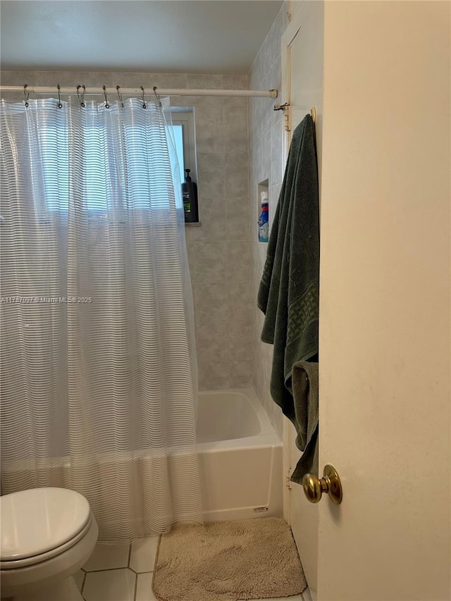 bathroom with shower / bath combo with shower curtain, tile patterned floors, and toilet