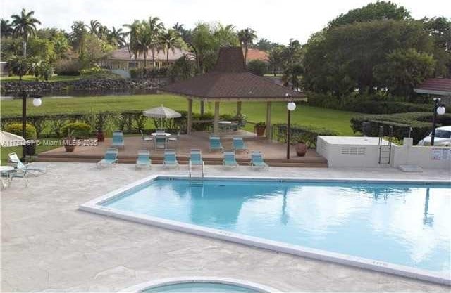 community pool featuring a gazebo and a patio area