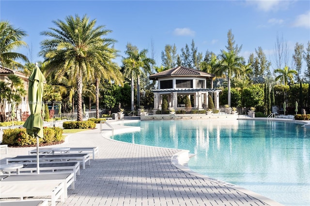 pool with a pergola and a patio