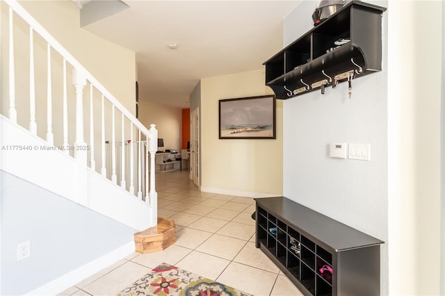 interior space featuring light tile patterned flooring and baseboards
