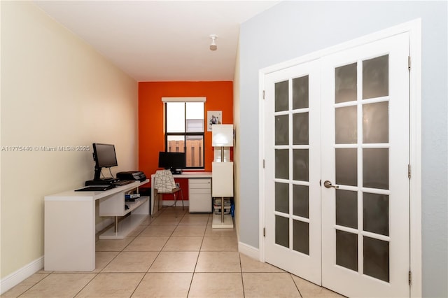 office space with french doors, baseboards, and light tile patterned flooring