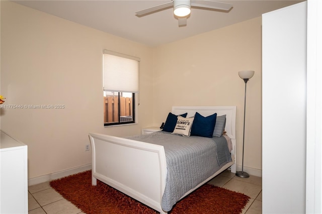 bedroom featuring a ceiling fan, baseboards, and light tile patterned floors