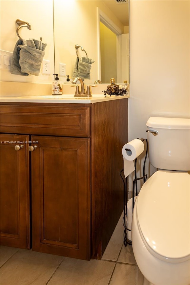 bathroom with vanity, toilet, and tile patterned flooring