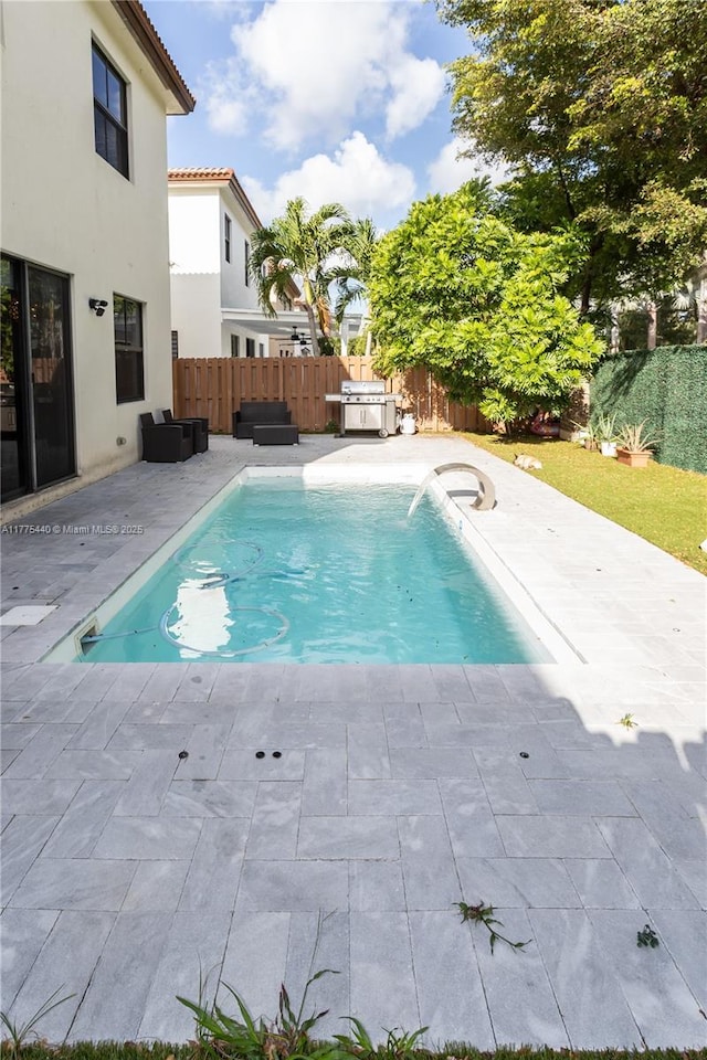 view of swimming pool with a fenced backyard, a jacuzzi, a patio, and a fenced in pool