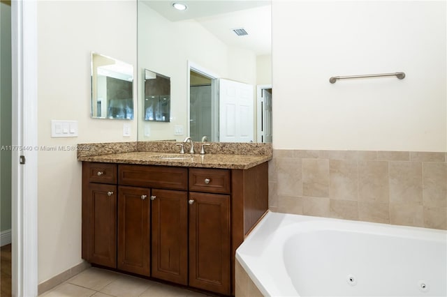 full bath featuring vanity, tile patterned flooring, a tub with jets, and visible vents