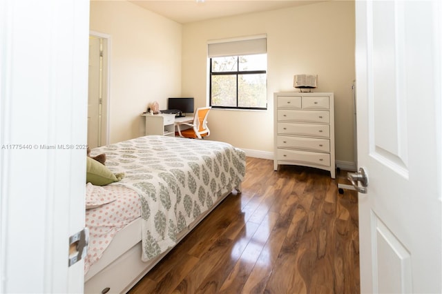 bedroom with baseboards and dark wood-style floors