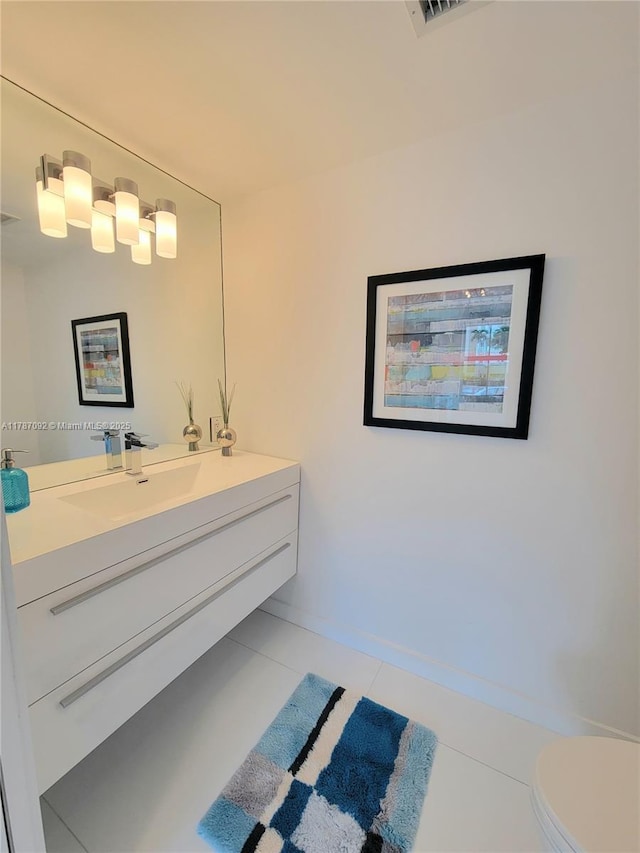 bathroom with toilet, visible vents, baseboards, tile patterned flooring, and vanity