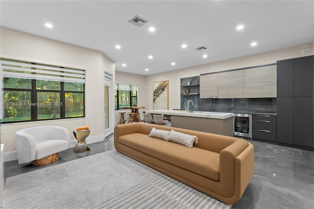 living area featuring wine cooler, visible vents, and recessed lighting