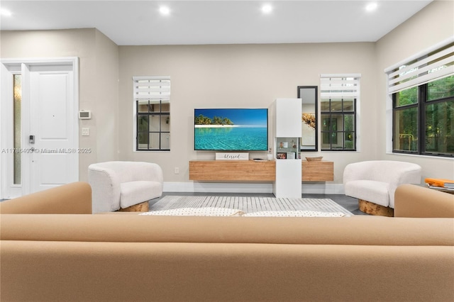 living area featuring baseboards and recessed lighting
