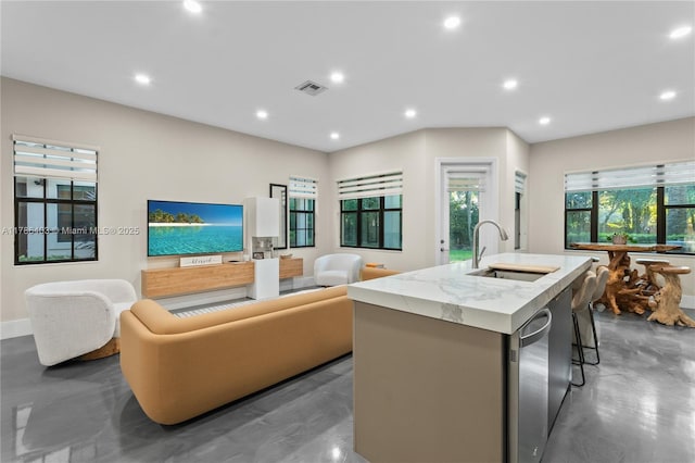 kitchen featuring a kitchen island with sink, a sink, open floor plan, visible vents, and recessed lighting
