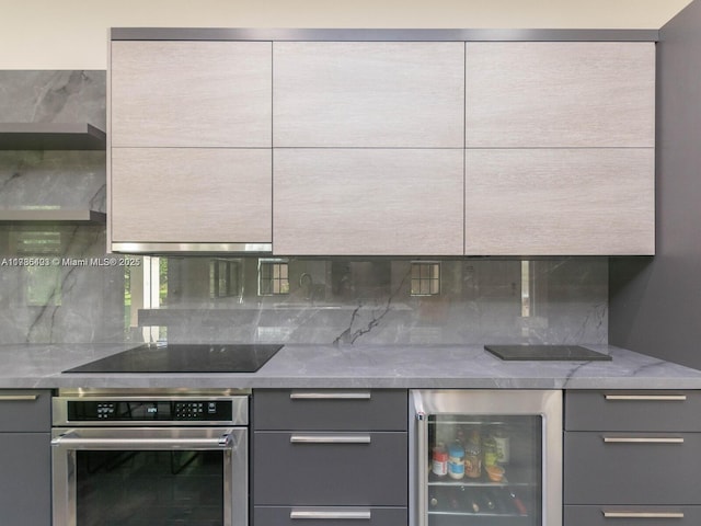 kitchen featuring decorative backsplash, stainless steel oven, black electric cooktop, gray cabinetry, and wine cooler