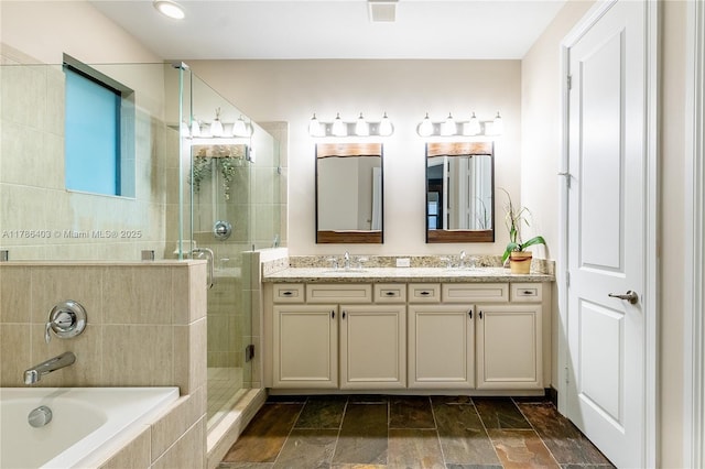 bathroom featuring double vanity, visible vents, a sink, a garden tub, and a stall shower