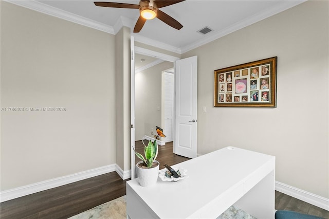 office area featuring a ceiling fan, dark wood-style flooring, crown molding, and visible vents