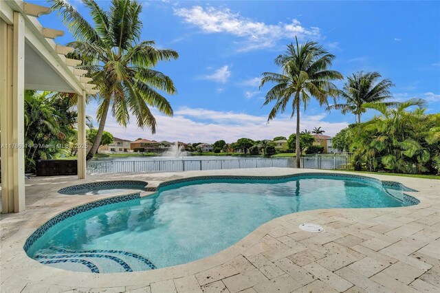 5337 SW 131st Ter, Miramar, FL 33027 - view of swimming pool with a patio area, a water view, and a pool with connected hot tub