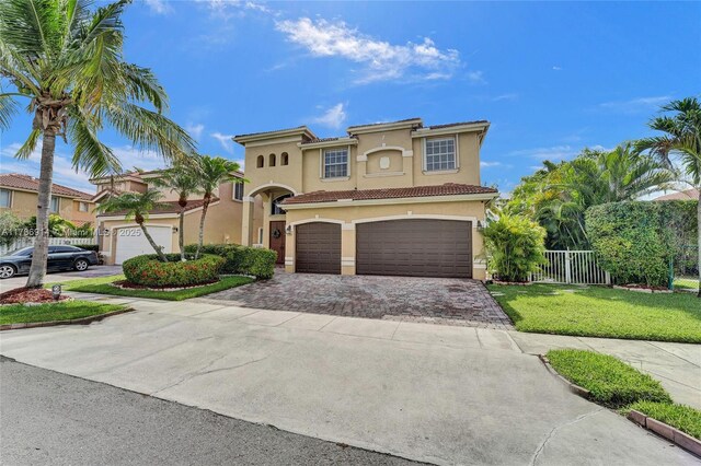 5337 SW 131st Ter, Miramar, FL 33027 - mediterranean / spanish house with stucco siding, driveway, an attached garage, and a tile roof