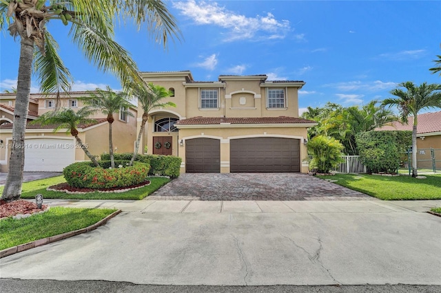 5337 SW 131st Ter, Miramar, FL 33027 - mediterranean / spanish house featuring stucco siding, decorative driveway, an attached garage, and a tile roof