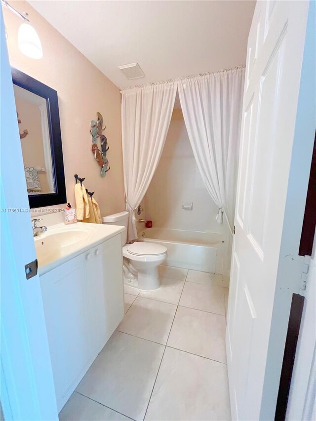 5337 SW 131st Ter, Miramar, FL 33027 - bathroom featuring vanity, shower / tub combo with curtain, toilet, and tile patterned flooring