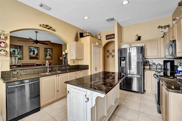 5337 SW 131st Ter, Miramar, FL 33027 - kitchen with appliances with stainless steel finishes, a sink, arched walkways, ceiling fan, and dark stone counters