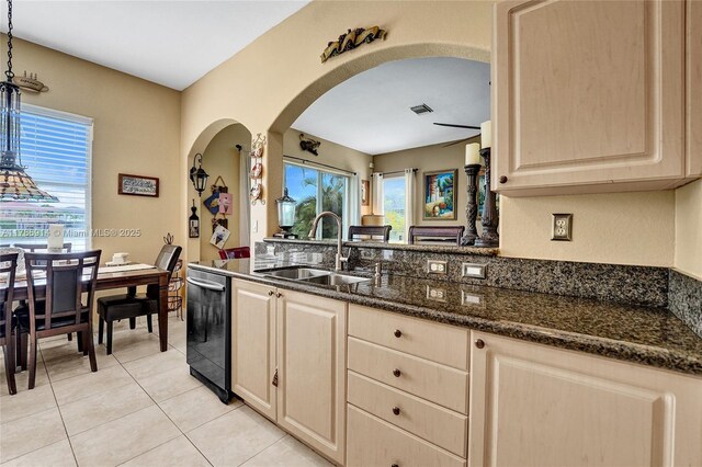 5337 SW 131st Ter, Miramar, FL 33027 - kitchen with a sink, dishwasher, arched walkways, dark stone counters, and light tile patterned floors